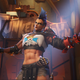 The Junker Queen in Overwatch 2 extends both her arms in front of a Junkertown sign.